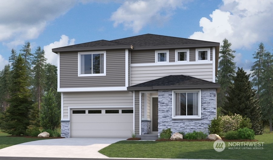 a front view of a house with a yard and garage