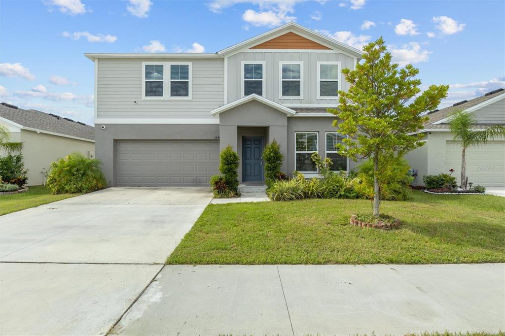 a front view of a house with a yard