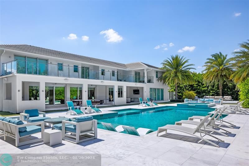 a view of a house with swimming pool and a yard