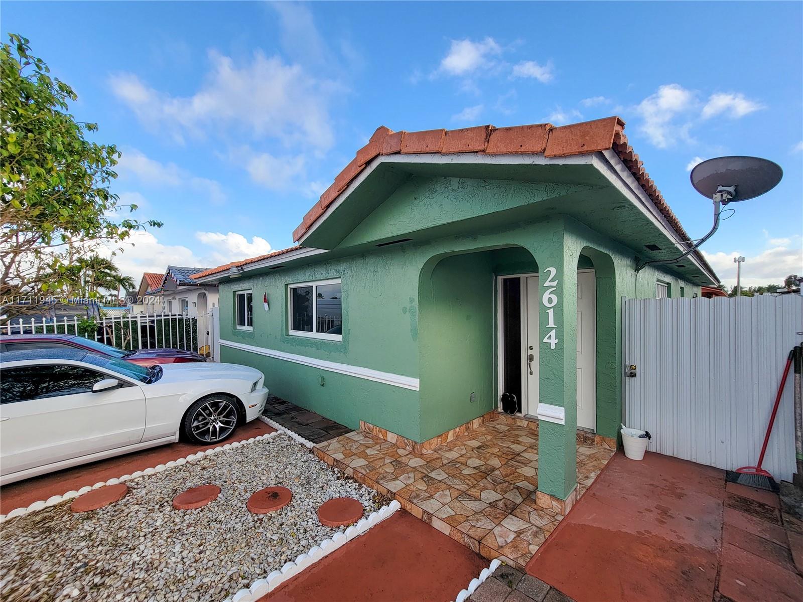 a front view of a house with parking space