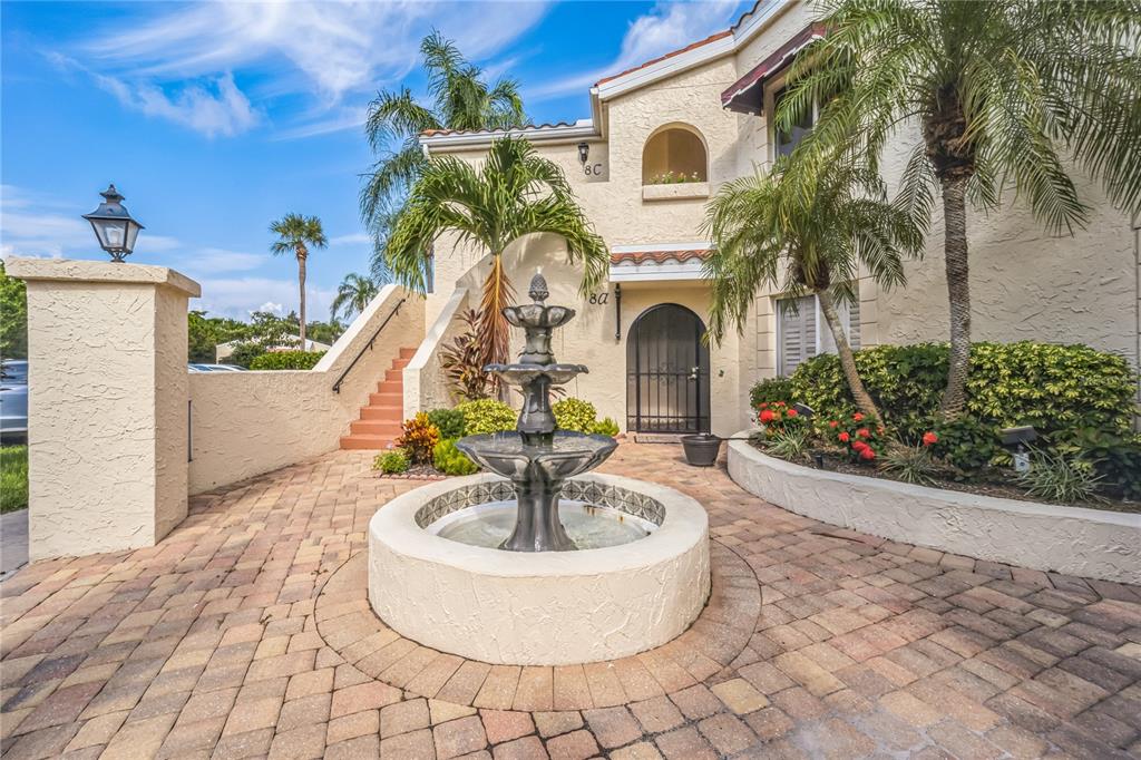 a front view of a house with a fountain