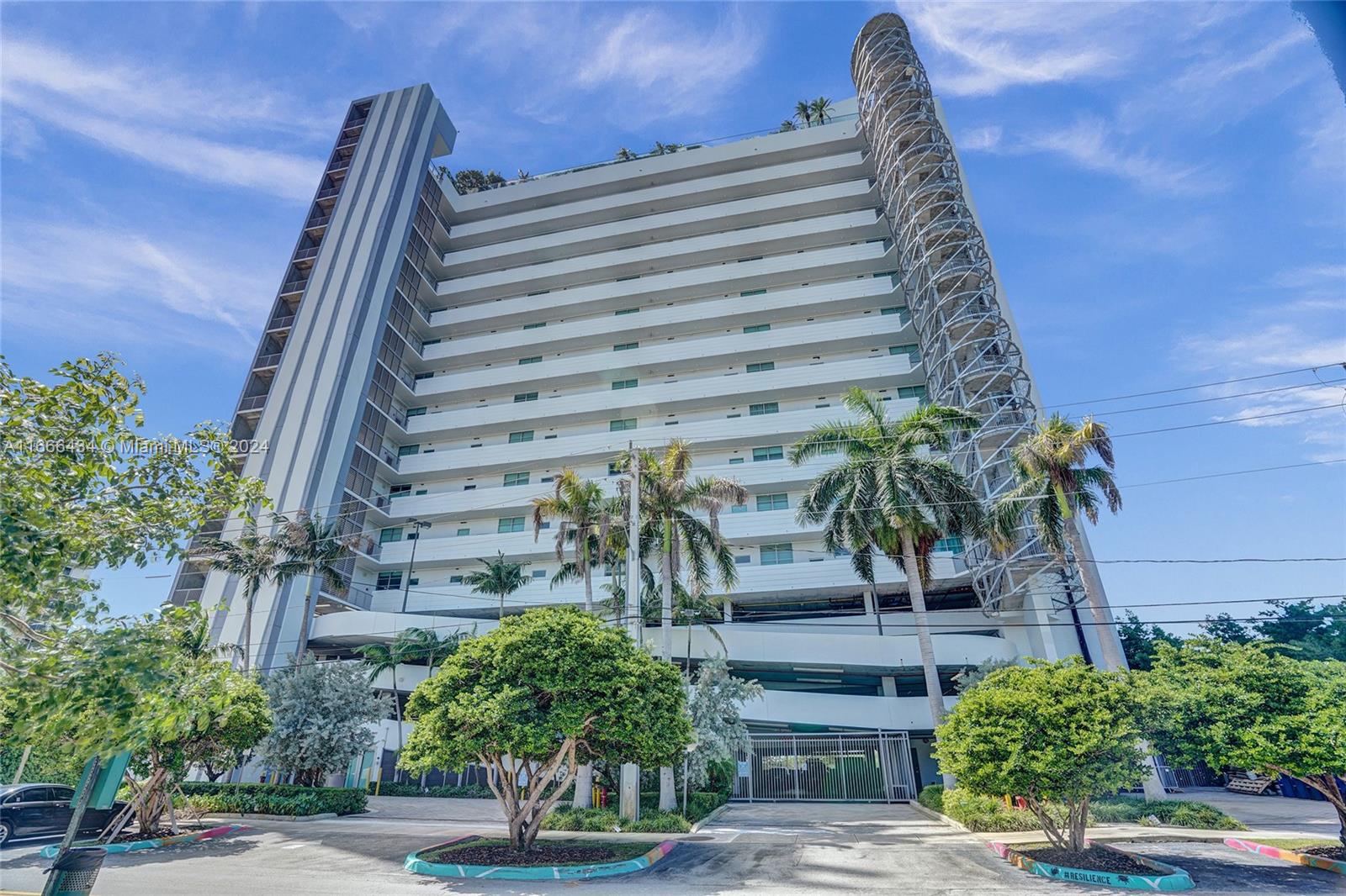 a view of a tall building next to a yard