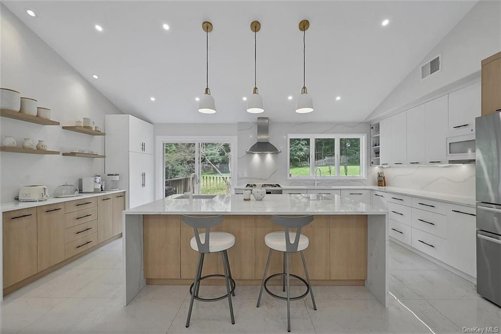a kitchen with stainless steel appliances kitchen island a large island in the center