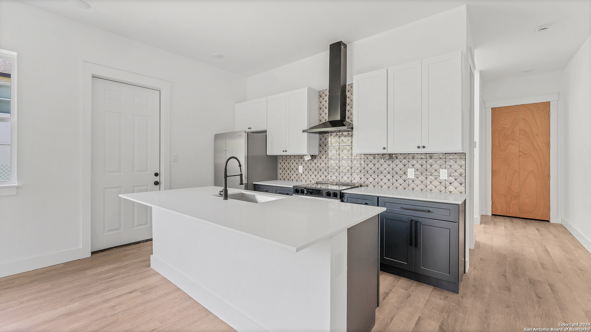 a kitchen with stainless steel appliances a sink stove and cabinets