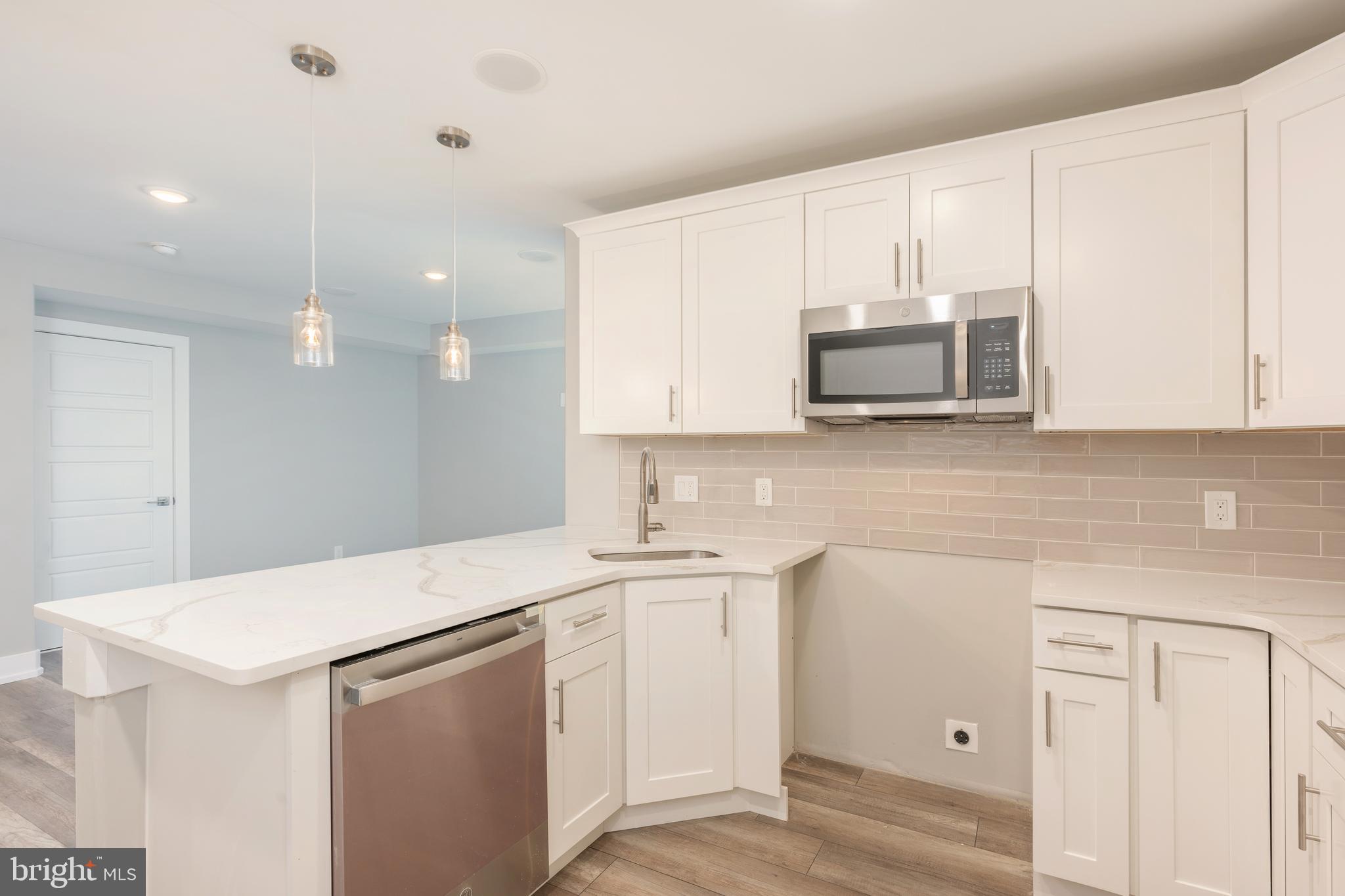 a view of a kitchen with sink and microwave