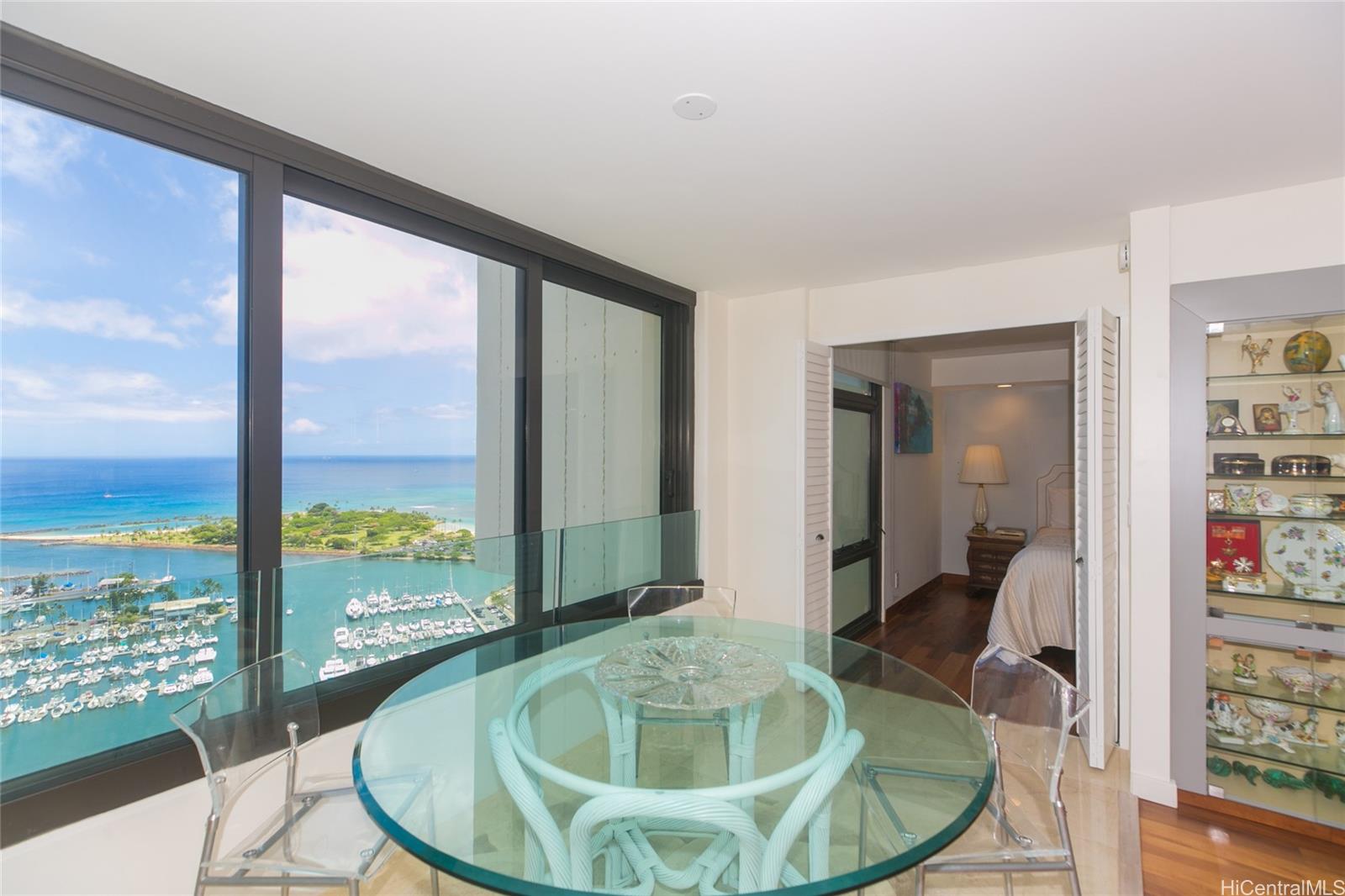 a dining room with a glass table and chairs