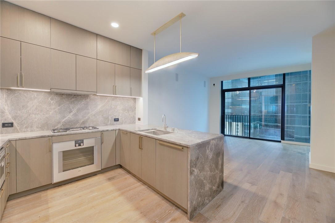 a kitchen with stainless steel appliances granite countertop a stove and a sink