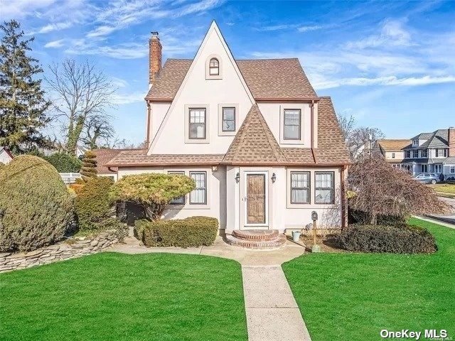 a view of a brick house with a yard