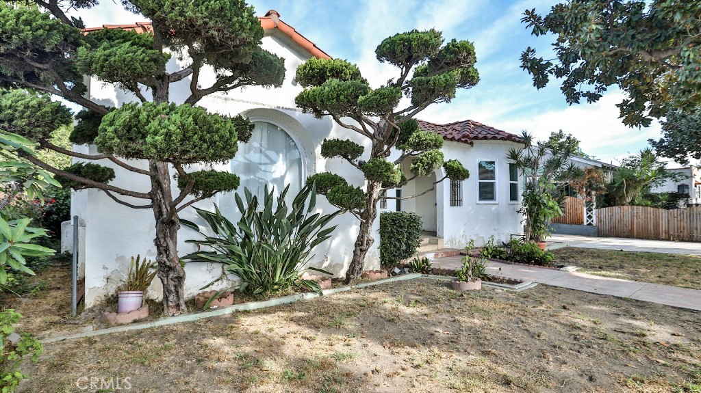 a view of a house with a tree and a yard