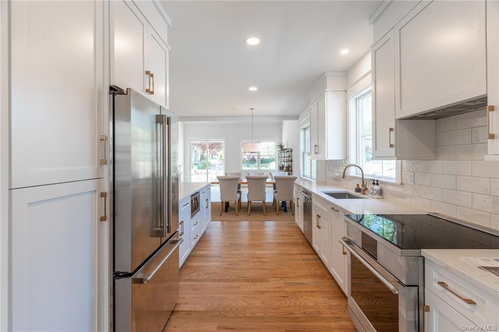 a kitchen with stainless steel appliances a sink stove and refrigerator