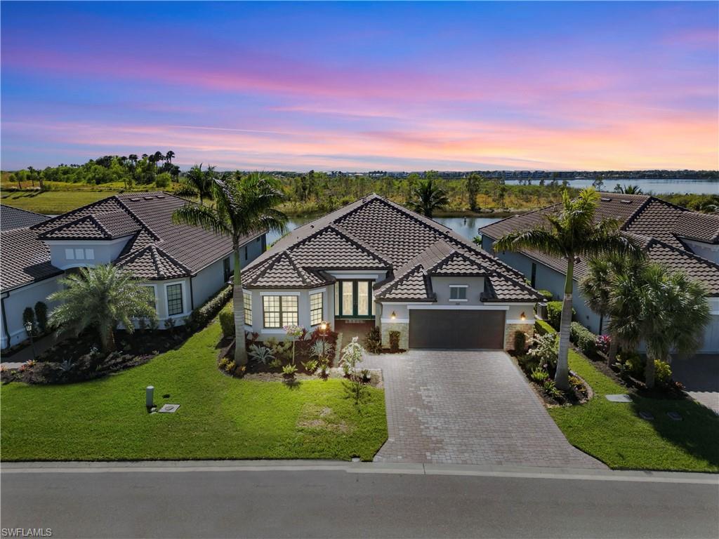 an aerial view of a house with a big yard