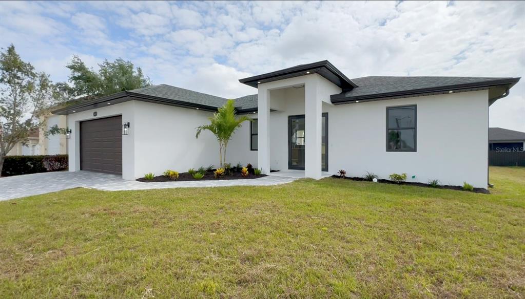 a front view of house with yard and trees