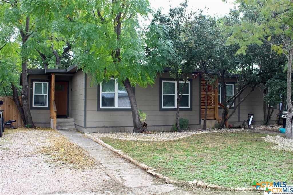 a view of a house with backyard and sitting area