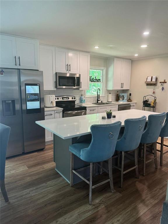 a kitchen with a dining table chairs and refrigerator