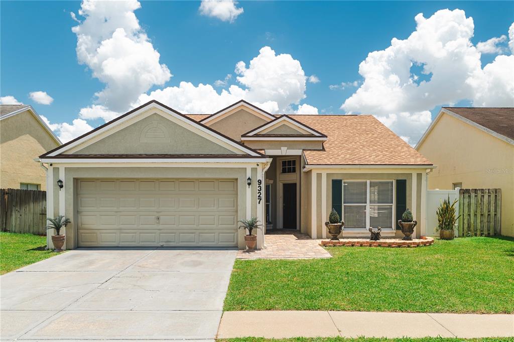 a front view of a house with a yard and garage