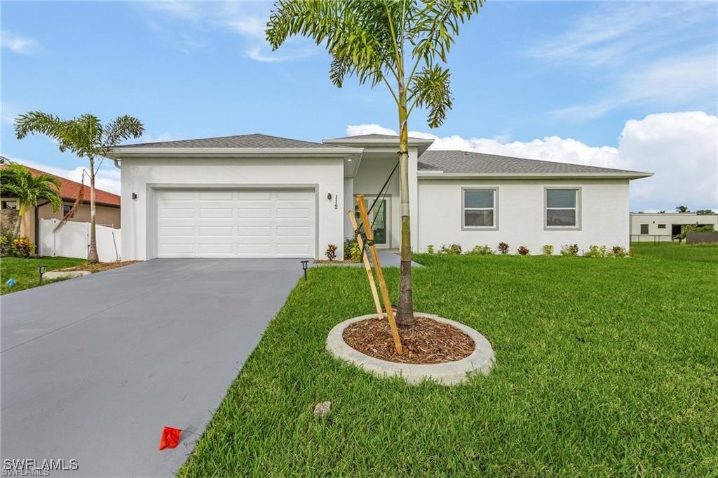 a front view of a house with a yard