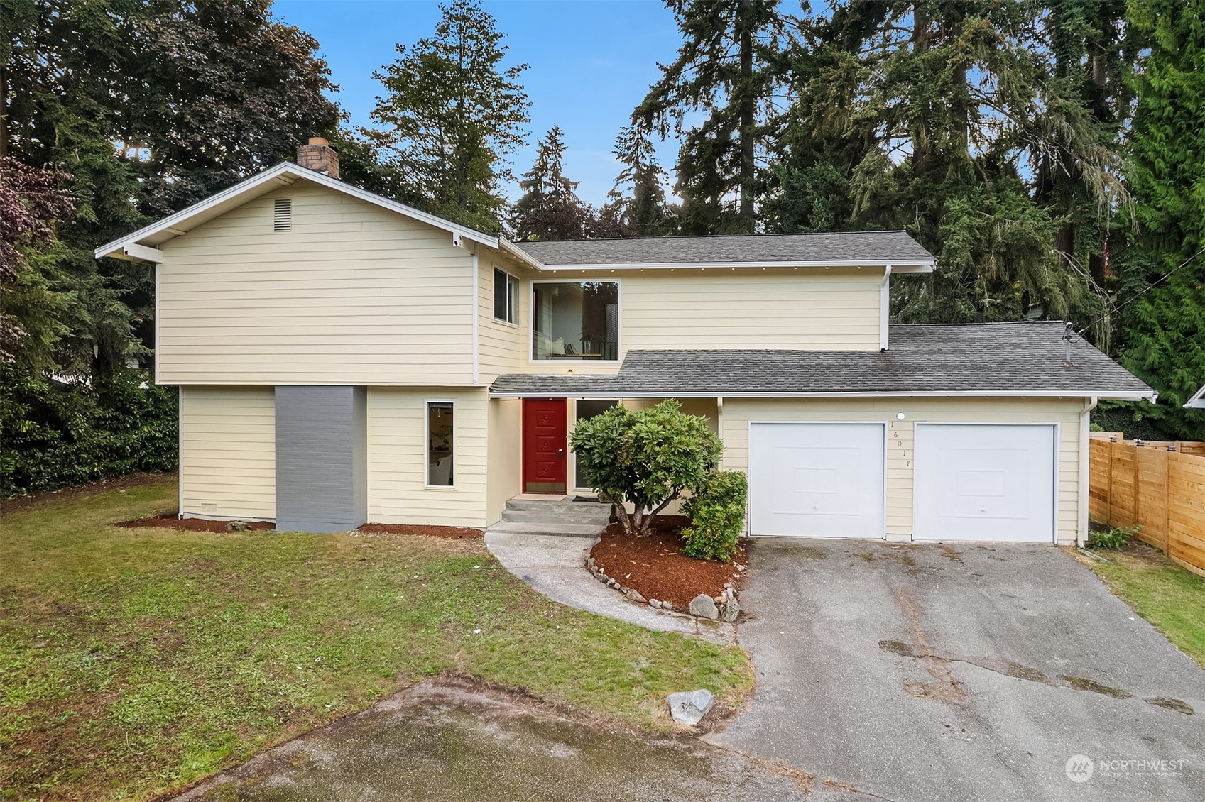 a front view of house with yard and trees