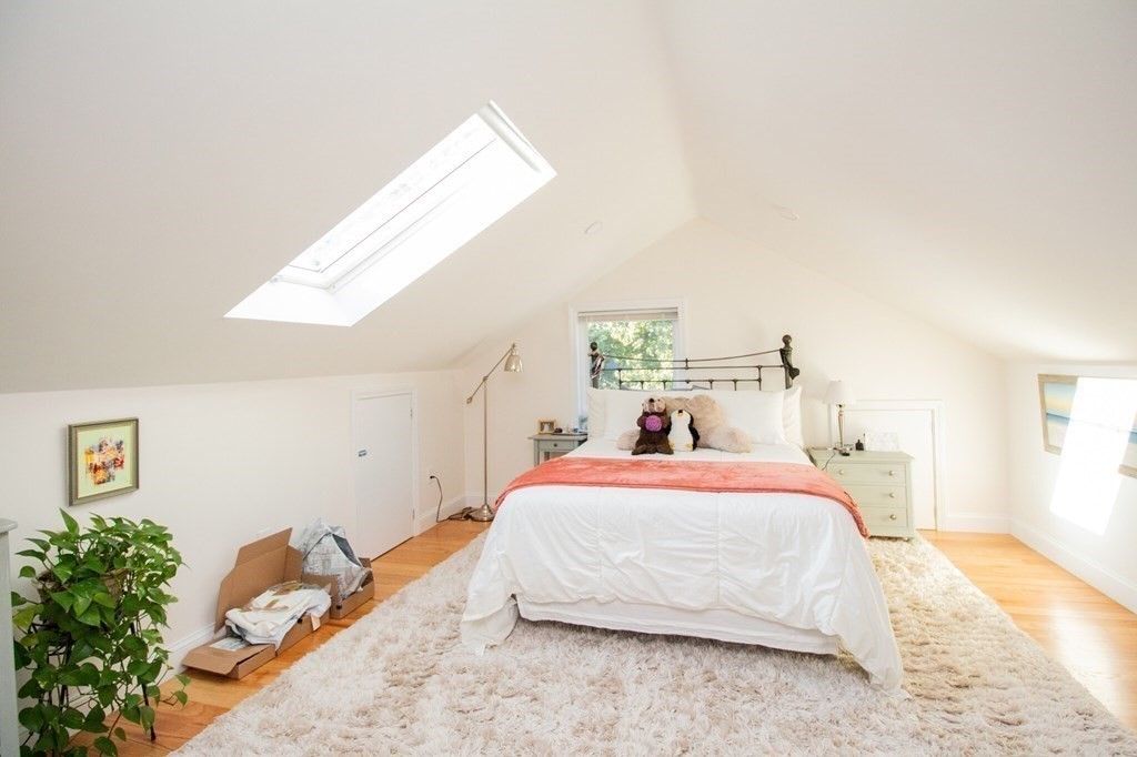 a bedroom with a bed and a potted plant