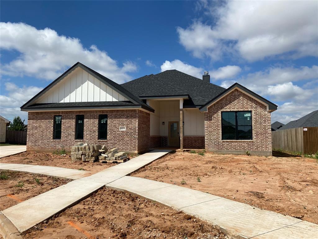 a front view of a house with yard and seating space