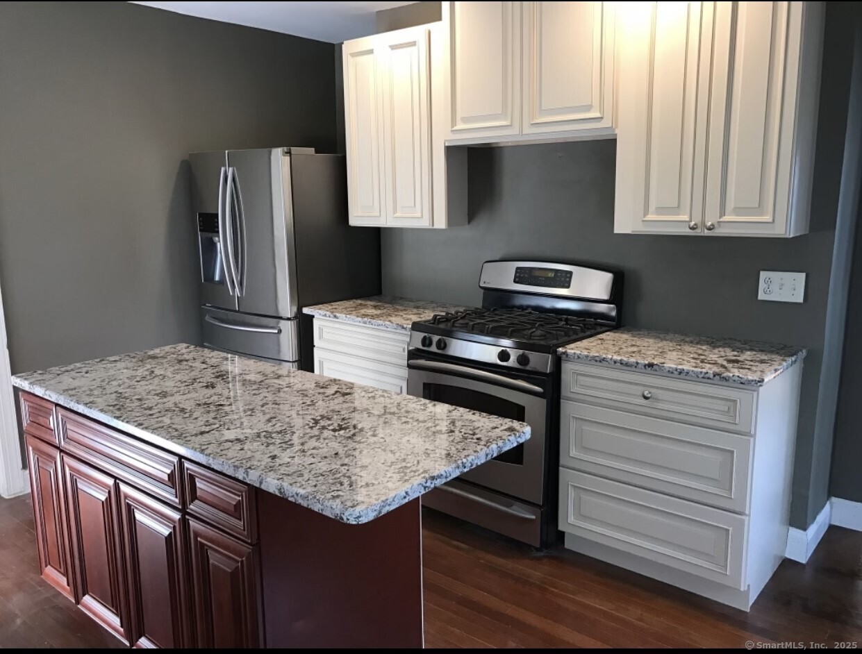 a kitchen with a sink stove and refrigerator