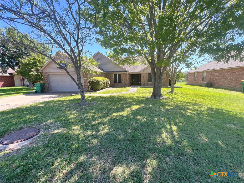 a brick house with trees in front of it