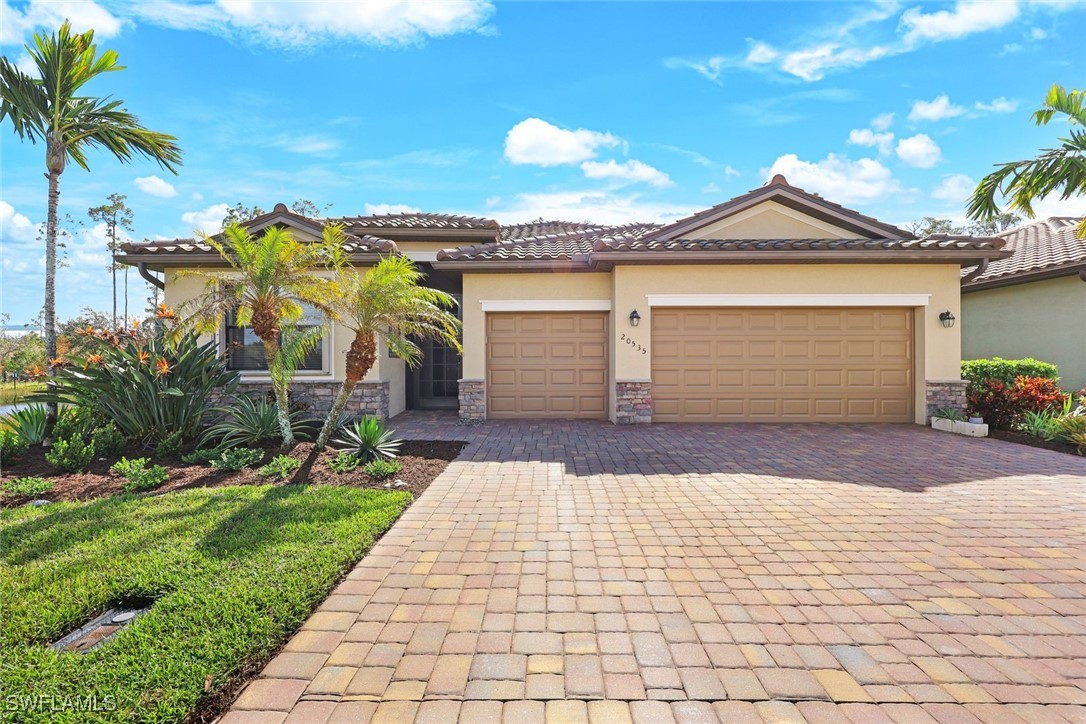 a front view of a house with a yard and garage