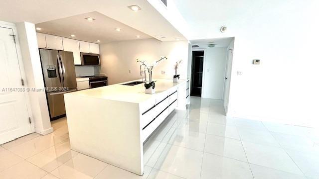 a kitchen with a sink a refrigerator and a stove