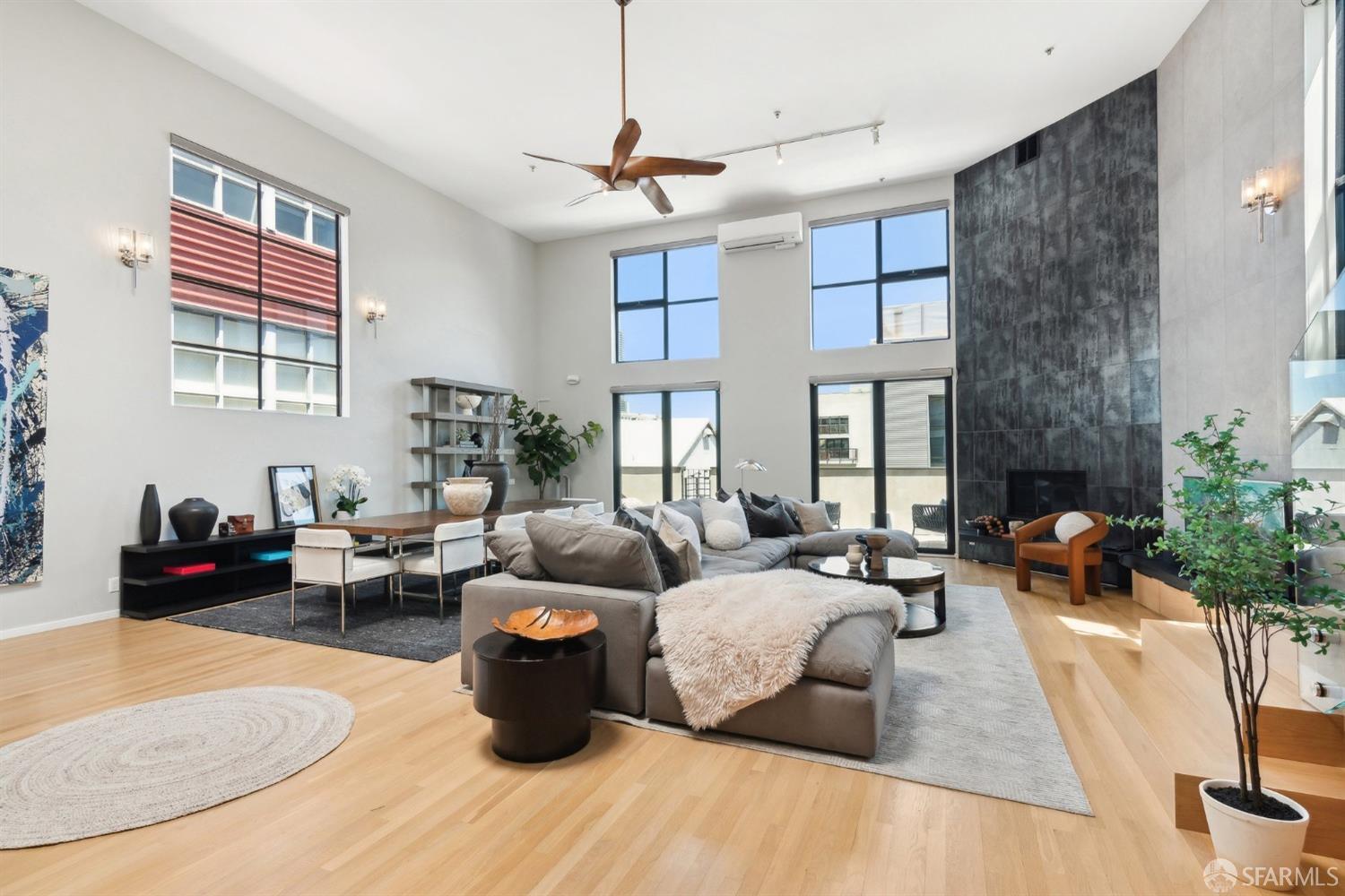 a living room with furniture wooden floor and a fireplace