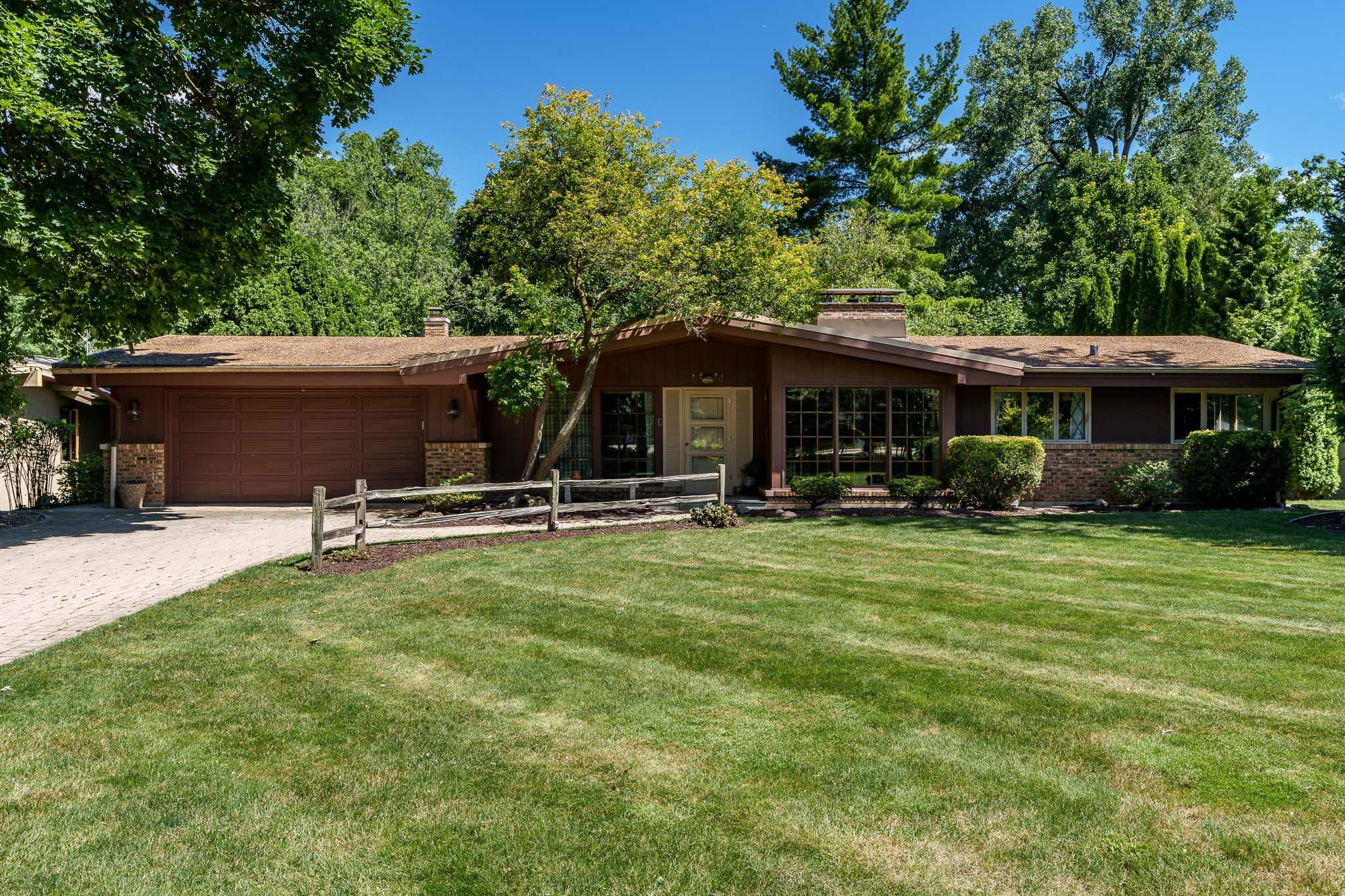 a view of a house with backyard porch and sitting area