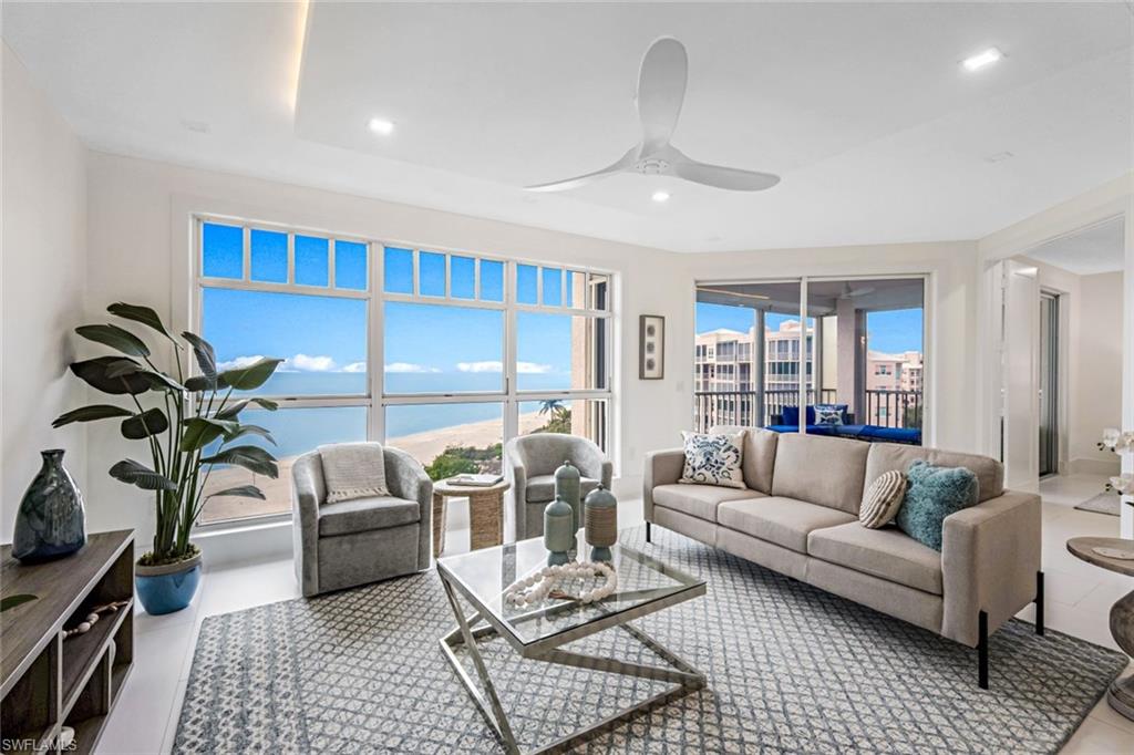 a living room with furniture ceiling fan and a rug