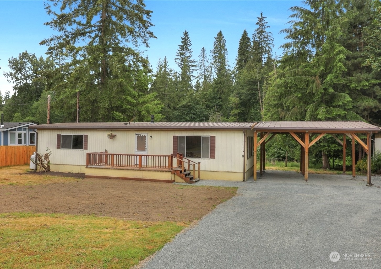 a view of a house with a backyard and a tree