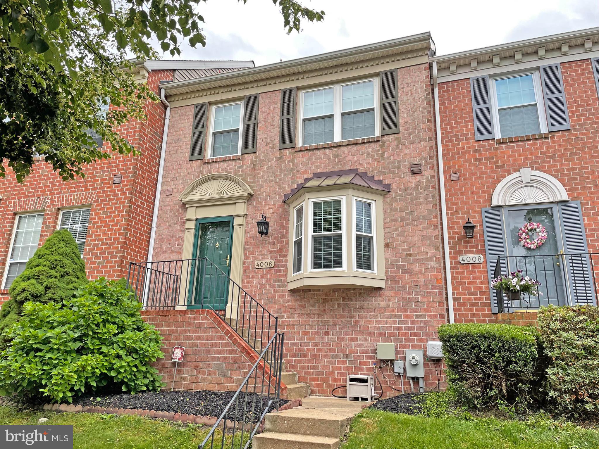 front view of a brick house with a yard