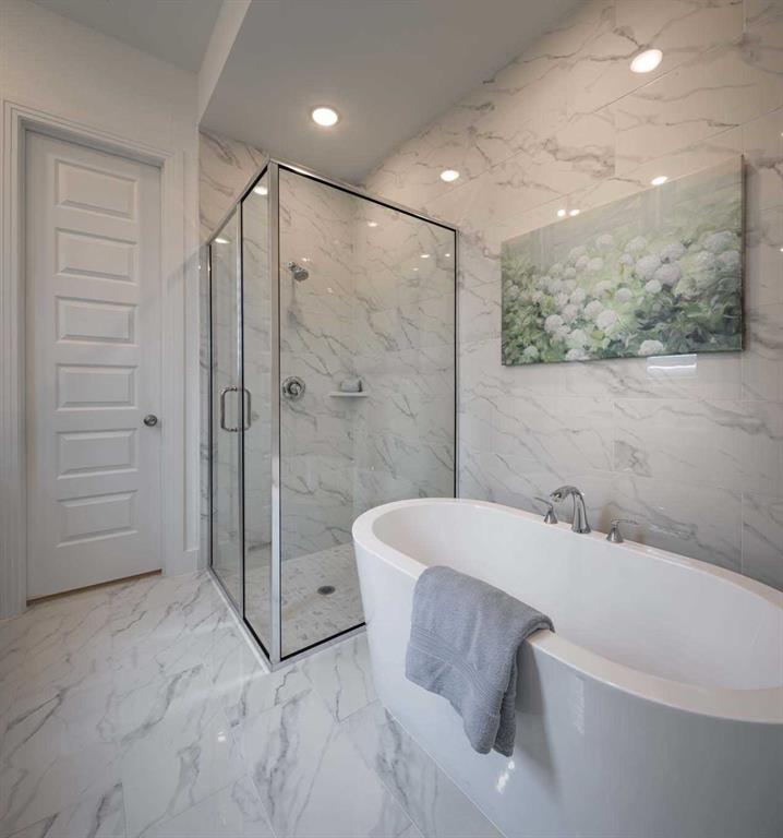 a bathroom with a bathtub and a shower