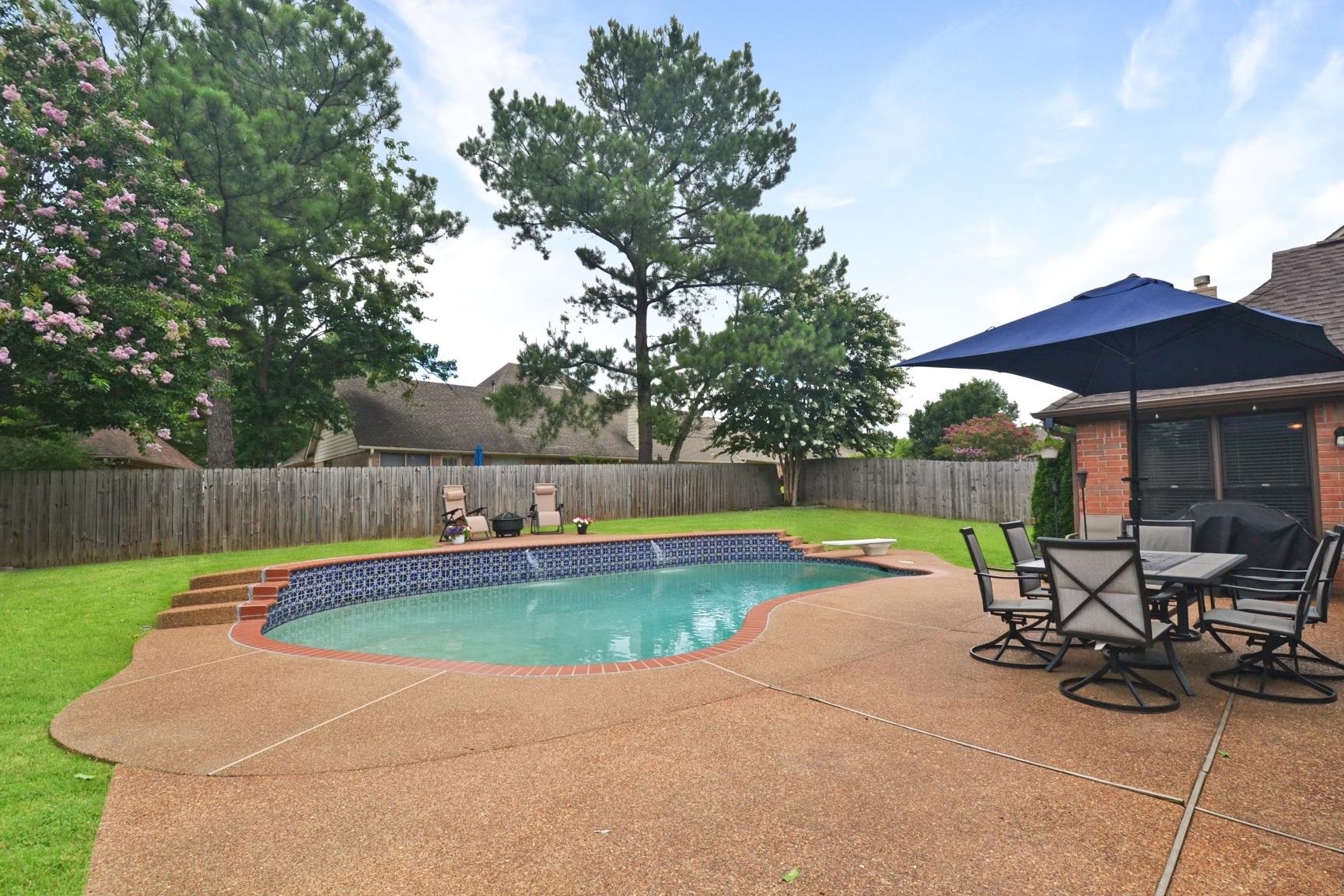 a view of swimming pool with sitting area and furniture