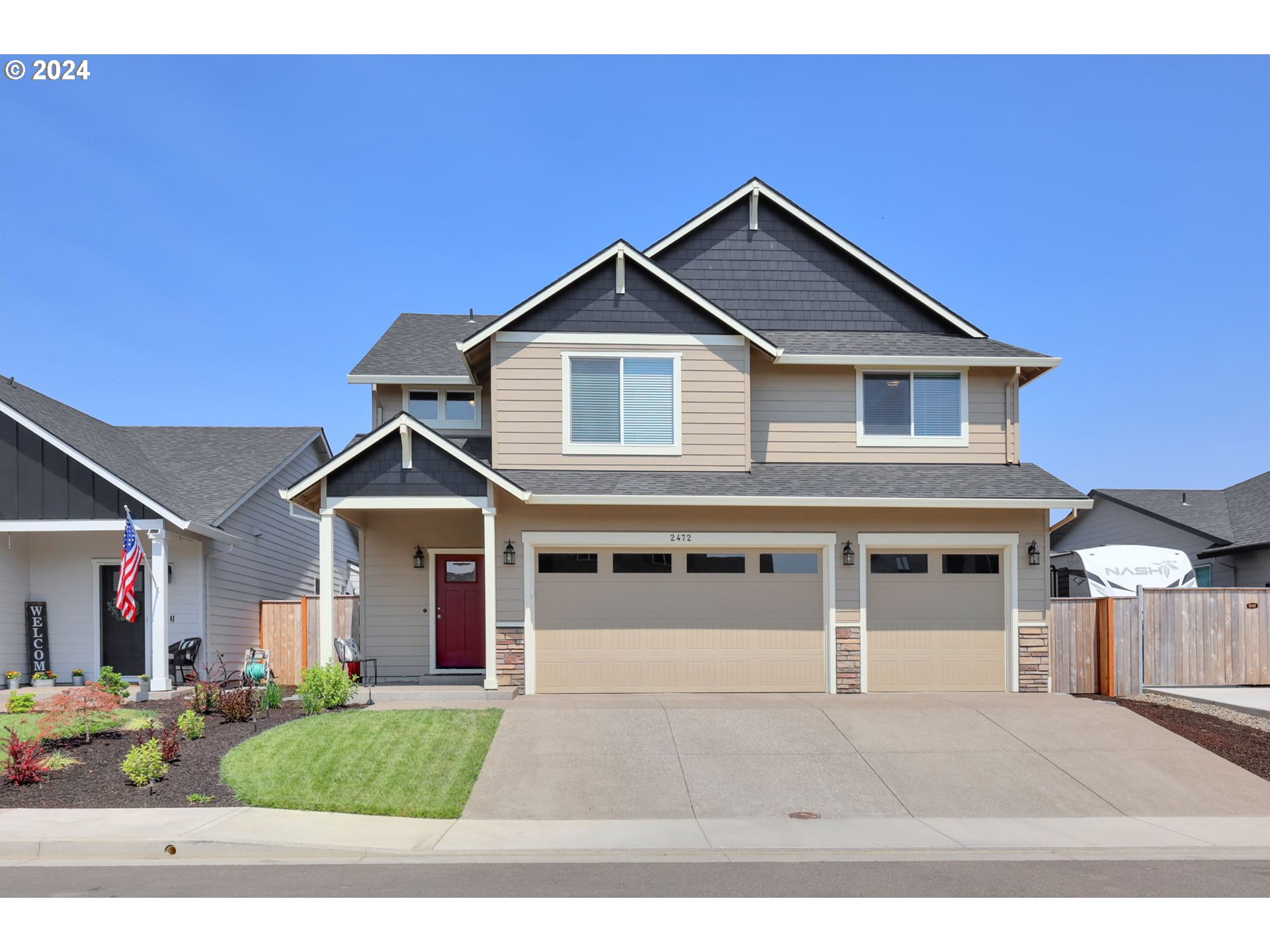 a front view of a house with a yard and garage