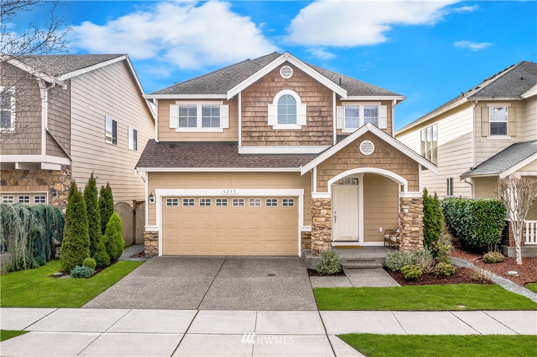 a front view of a house with a yard and garage