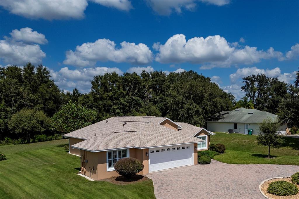 an aerial view of a house with yard porch and mountain view in back