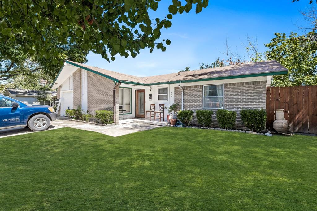 a view of a house with a patio and a yard