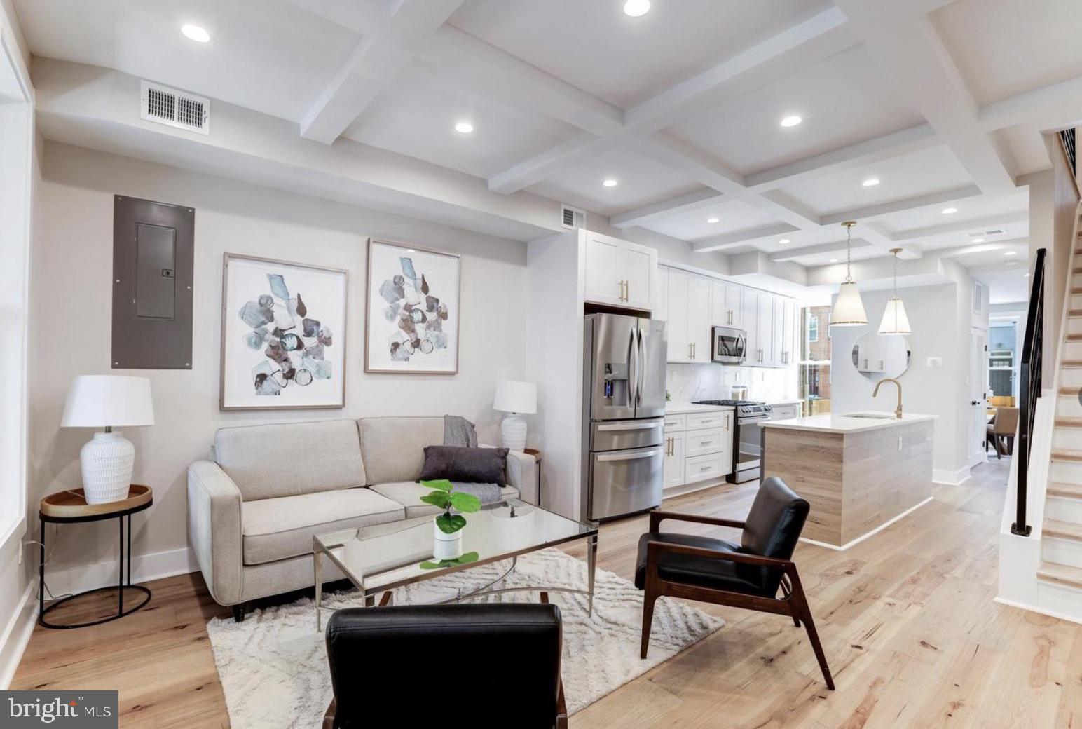 a living room with furniture a refrigerator and a coffee table