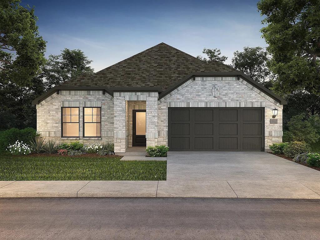 a front view of a house with a garden and garage