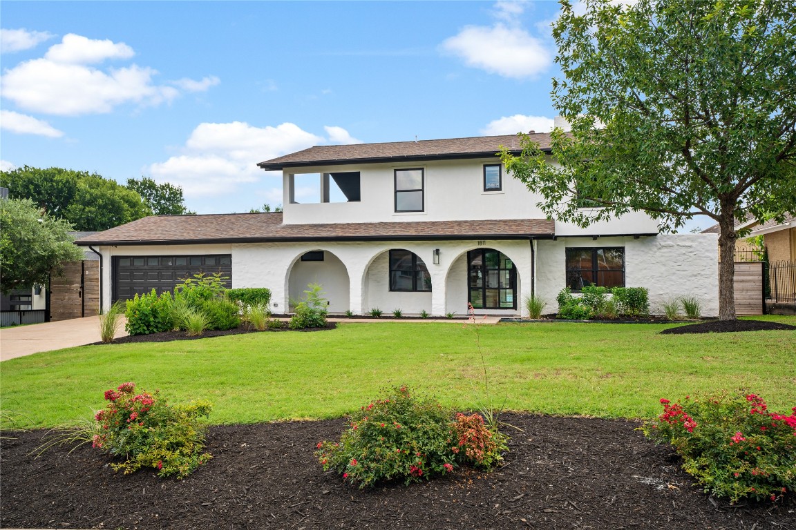 a front view of a house with garden