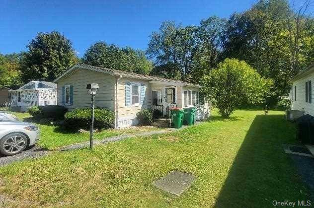 a view of a house with a backyard