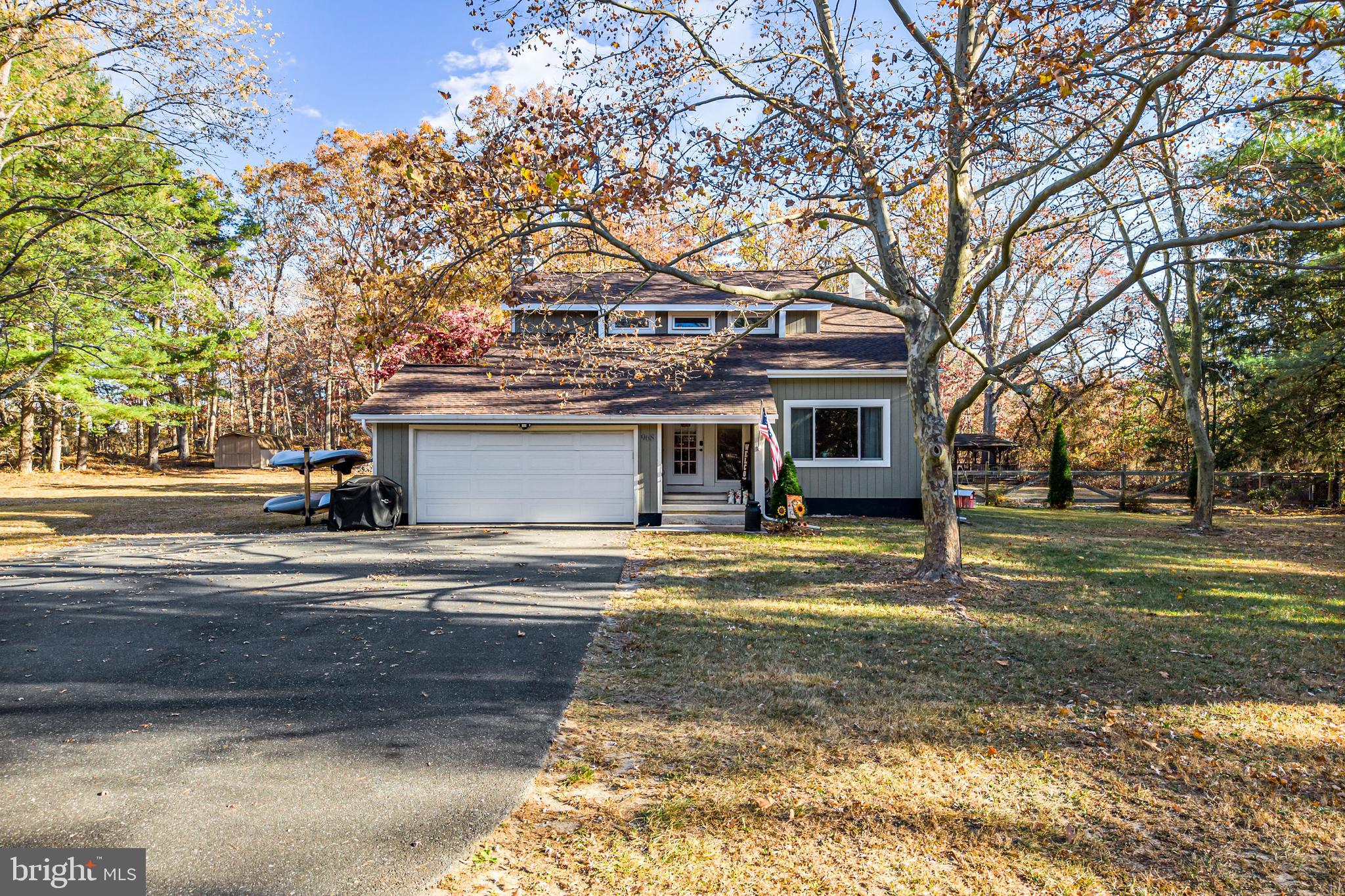 a view of a house with a yard and tree s