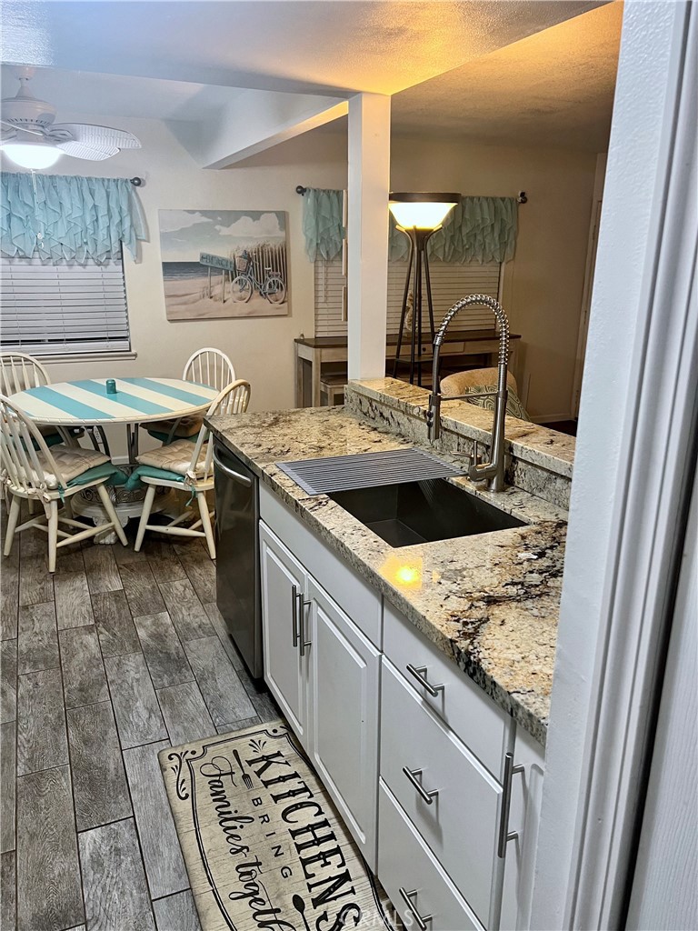 a spacious bathroom with a granite countertop sink and a mirror