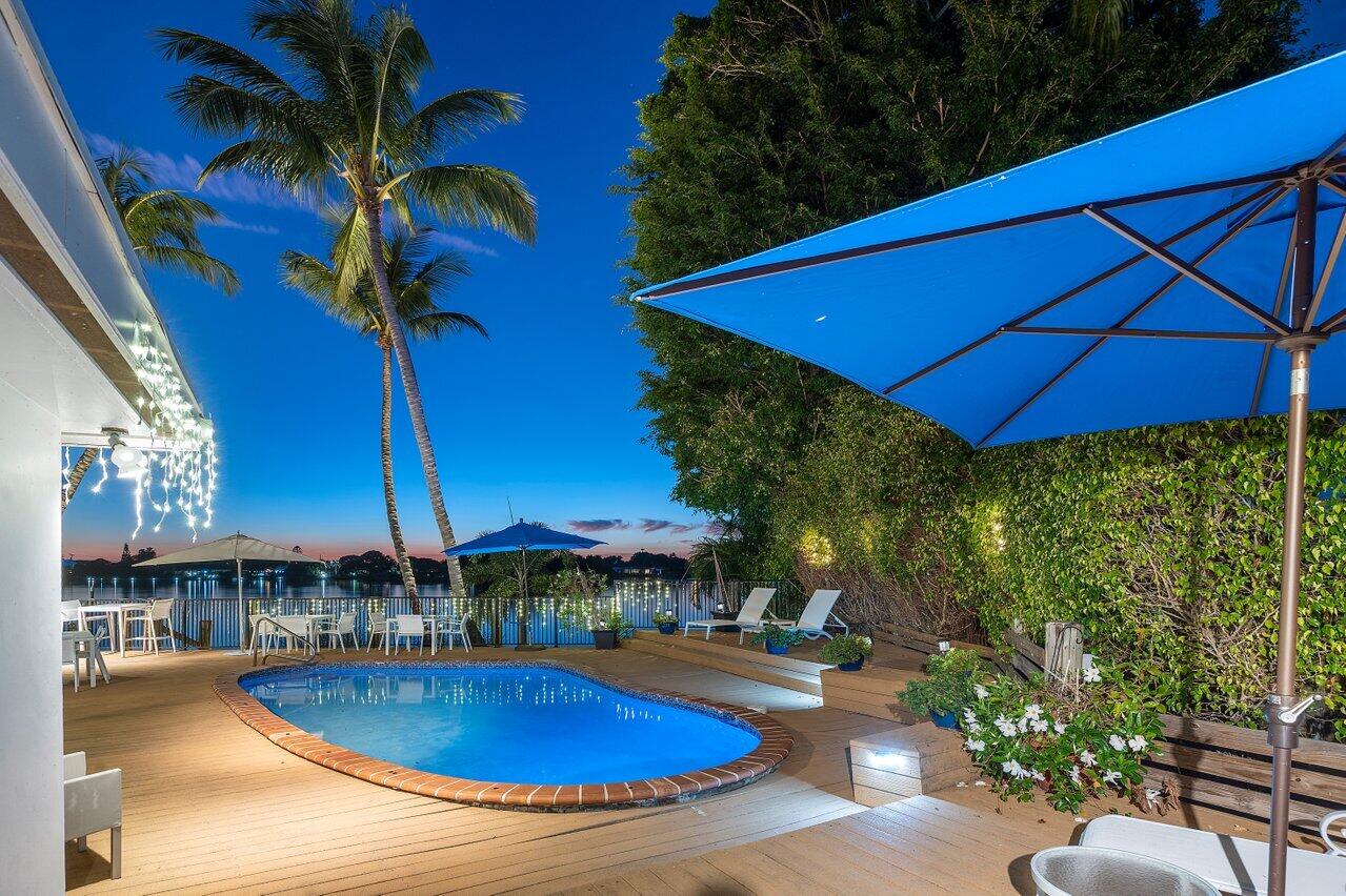 a view of a swimming pool with chairs in patio