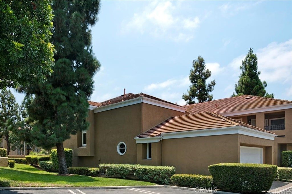 a house that has a tree in front of it