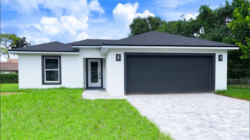 a front view of a house with a yard and garage