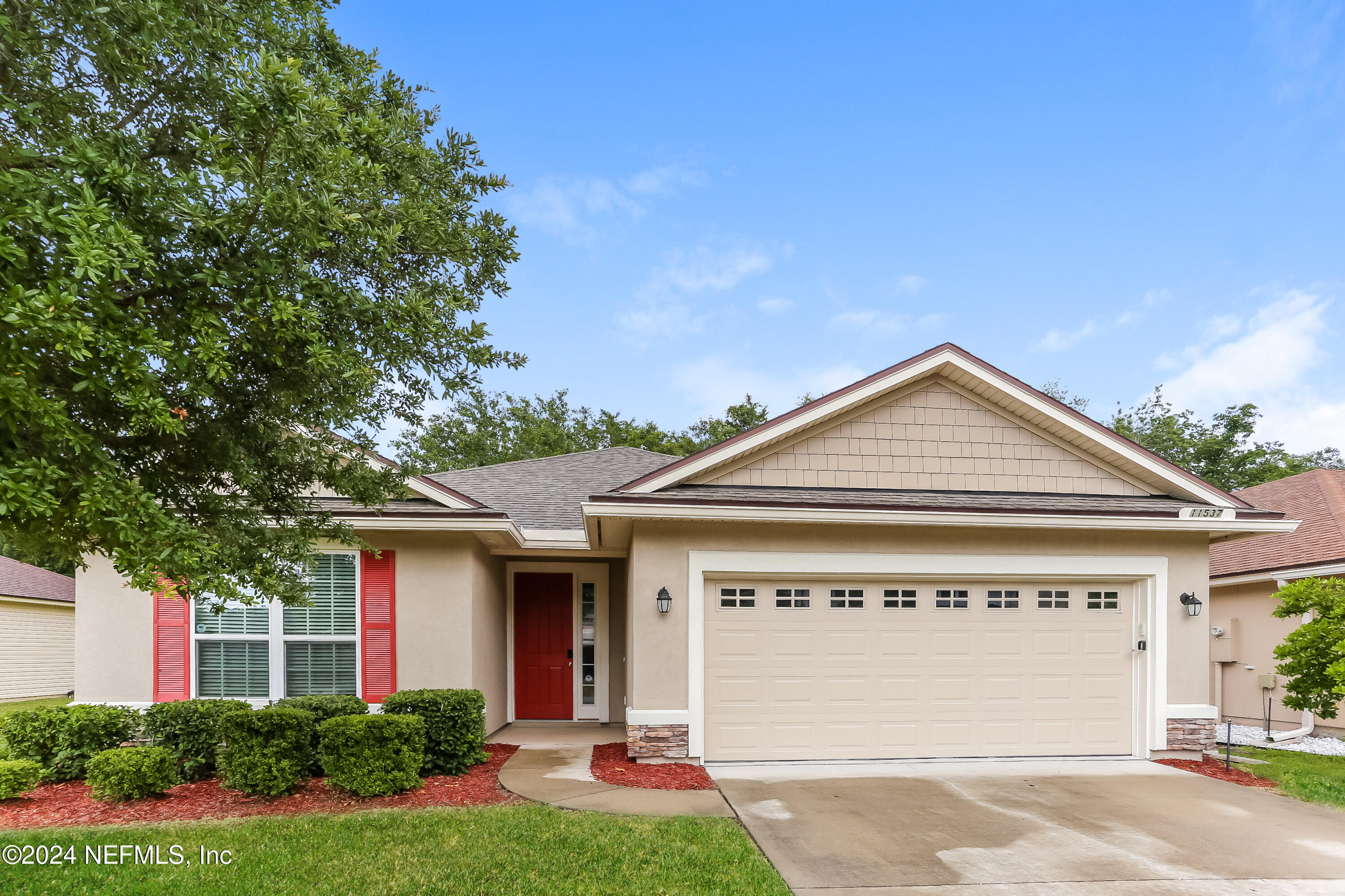 a front view of a house with a yard and garage