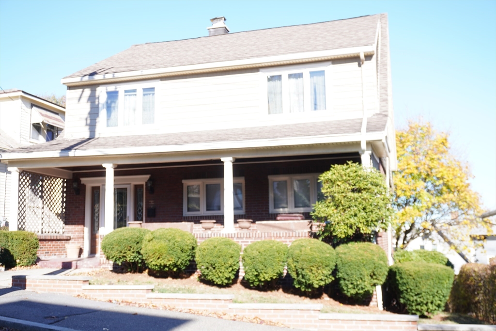 a view of a house with potted plants