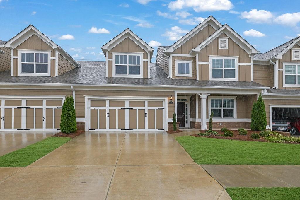 a front view of a house with a yard and porch